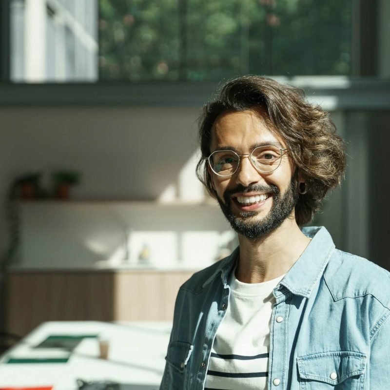 young-man-with-beard-and-eyeglasses-employee-worker-of-a-tech-creative-startup-company.jpg